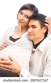 Peaceful Lovely Dreaming Caucasian Couple with Pregnant Woman While Sitting Embraced Over White Background. Vertical Composition - Shutterstock ID 2007627167