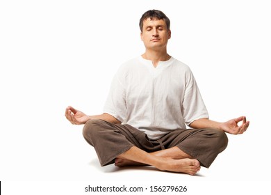 Peaceful Man Doing Yoga And Meditating - Isolated Over A White Background