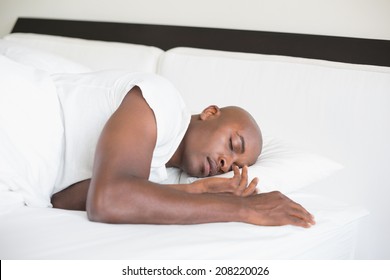 Peaceful man sleeping in bed at home in the bedroom