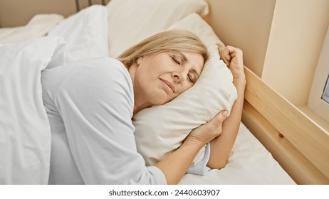 A peaceful middle-aged blonde woman sleeping comfortably alone in a cozy bedroom setting. - Powered by Shutterstock