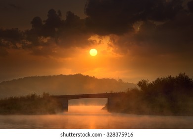 Peaceful Nature Scene On The Lake With Bridge At Misty Dawn Towards The Rising Sun. Knic Lake, Serbia.