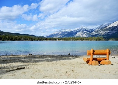 Peaceful Orange Bench with Spectacular View of Clear Lake and Rocky Mountains