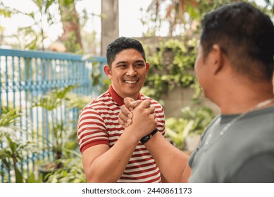 Peaceful resolution by an Asian man mediating an outdoor argument between friends. - Powered by Shutterstock