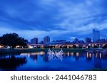 Peaceful scenery and reflections during the blue hour before sunrise in early summer near the Sanchong Station of Taoyuan Airport MRT in the New Taipei City Metropolitan Park.