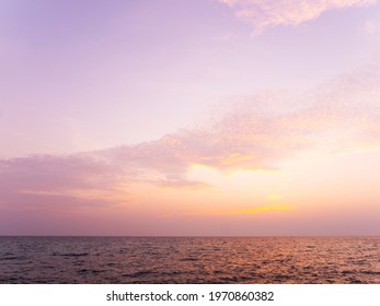 Peaceful Serene Sea Scape And Golden Purple Tone Sunset Or Sunrise Sky With Clouds, Tropical Island Ocean View At Dawn Or Dusk