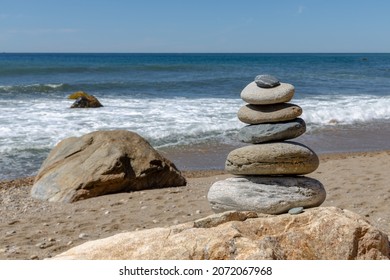 peaceful stack of rocks on a beach with waves
