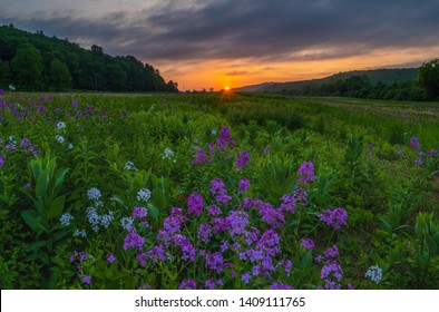 Peaceful sunrise over Delaware Water Gap, Pennsylvania featuring meadows on the foreground and mountains on the background