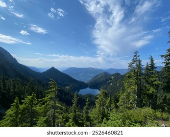 A peaceful view of Mount MacFarlane, BC, featuring an alpine lake, lush forests, and rugged peaks under a vivid blue sky. Perfect for capturing nature, outdoor adventure, scenic wilderness landscape - Powered by Shutterstock