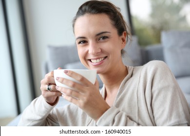 Peaceful Woman Relaxing At Home With Cup Of Tea