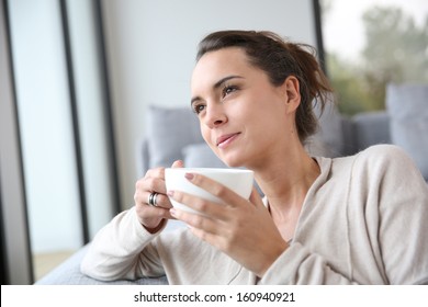 Peaceful Woman Relaxing At Home With Cup Of Tea