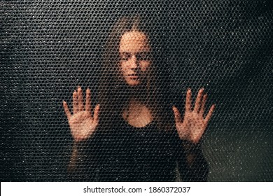 Peaceful Woman. Soul Healing. Spiritual Practice. Esoteric Mystery. Textured Portrait Of Relaxed Lady In Black With Closed Eyes Touching Plastic Bubble Wrap Wall In Darkness.