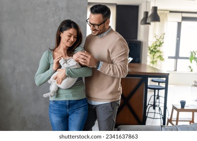 Peaceful young married couple enjoying being family, parents, holding new born baby in arms - Powered by Shutterstock