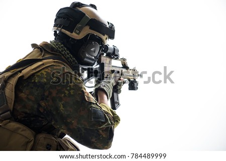 Peacemaker looking at sniper scope of modern weapon while turning back to camera. Military concept. Isolated and copy space