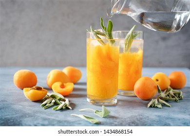 Peach Or Apricot Nectar With Sage In Glass. Refreshing Cold Drink