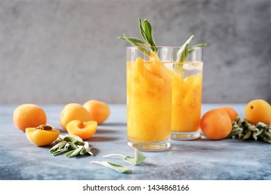 Peach Or Apricot Nectar With Sage In Glass. Refreshing Cold Drink