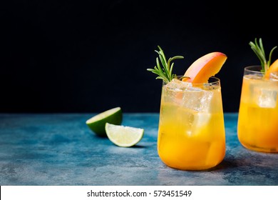 Peach Cocktail, Fizz With Rosemary On Blue Stone Background. Copy Space