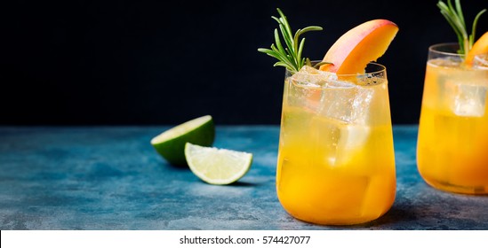 Peach Cocktail, Fizz With Rosemary On Blue Stone Background. Copy Space