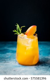 Peach Cocktail, Fizz With Rosemary On Blue Stone Background. Copy Space