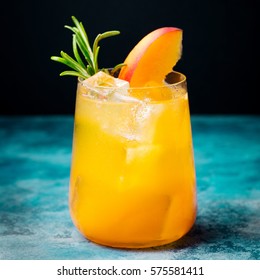 Peach Cocktail, Fizz With Rosemary On Blue Stone Background. Copy Space