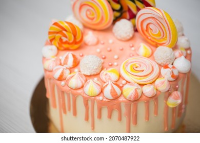 Peach Colored Cake With Meringue And Candy For A Child's Birthday