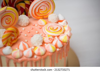 Peach Colored Cake With Meringue And Candy For A Child's Birthday