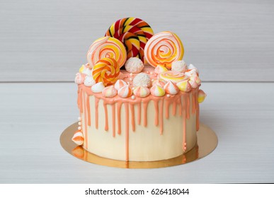 Peach Colored Cake With Meringue And Candy For A Child's Birthday