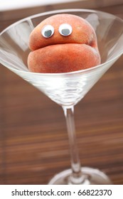 Peach With Eyes In The Glass Martini On A Bamboo Mat