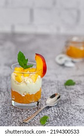 Peach Fruit Dessert In A Glass Cup With Curd Cream And Peach Jam.