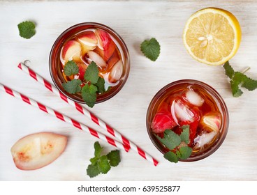 Peach Ice Tea In Glass On White Wooden Background. View From Above