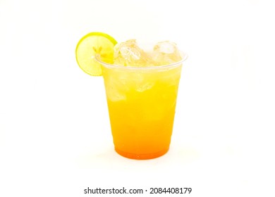 Peach Mango Drink Filled With Ice Cubes And Lemon Slice. 