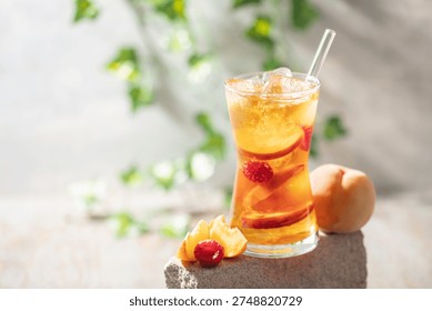 Peach Raspberry iced Tea in galss. Summer refreshing drink