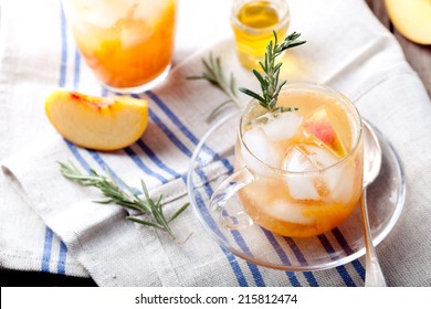 Peach And Rosemary Fizz Cocktail On A Wooden Background.