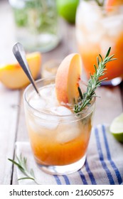 Peach And  Rosemary Fizz, Cocktail On A Wooden Background.