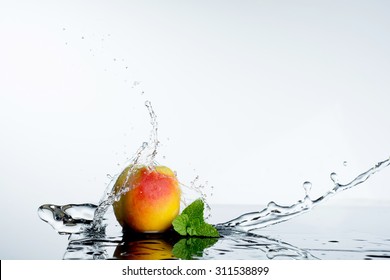 Peach in spray of water. Juicy peach with splash on white background.
