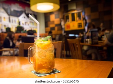 Peach tea with lemon in a glass ready to served at the restaurant.