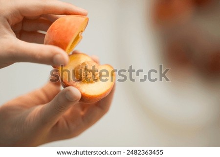 peaches in hand, peaches and hands, split peach
