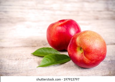 Peaches On A White Wood Background. Toning. Selective Focus On Right Peach.