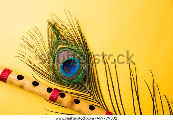 Peacock Feather Bamboo Flute Over Colourful Stock Photo (Edit Now