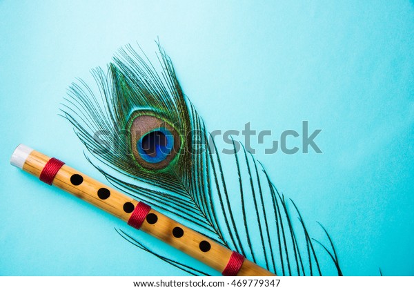 Peacock Feather Bamboo Flute Over Colourful Stock Photo (Edit Now