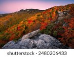 Peak autumn foliage and soft predawn light over the blue ridge mountains of North Carolina