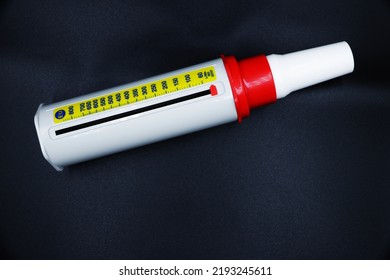 A Peak Flow Meter With A Disposable Mouthpiece. Peak Flow Test Used In The Treatment Of Asthma. Image Isolated On A Black Background.