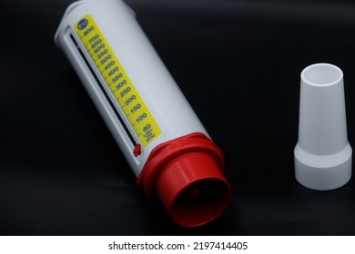 A Peak Flow Meter With A Disposable Mouthpiece. Peak Flow Test Used In The Treatment Of Asthma. Image Isolated On A Black Background.