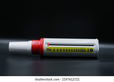 A Peak Flow Meter With A Disposable Mouthpiece. Peak Flow Test Used In The Treatment Of Asthma. The Image Is Isolated On A Black Background.