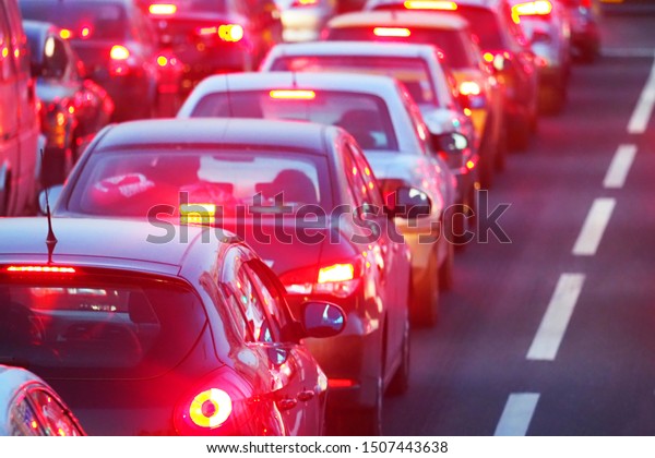 Peak hour.\
Automobile brake lights. Traffic jam on a highway street in city.\
Cars stand before the\
trafficlight