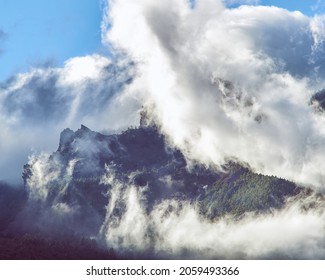The peak of a mountain surrounded by clouds