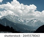 Peaks coverded with snow  with clouds covering 