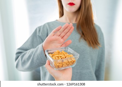 Peanut Allergy Concept - Food Intolerance. Young Girl Refuses To Eat Peanuts - Shallow Depth Of Field