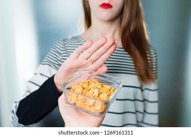 Peanut Allergy Concept - Food Intolerance. Young Girl Refuses To Eat Peanuts - Shallow Depth Of Field