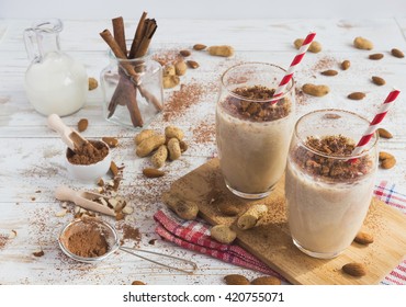 Peanut And Almond Butter Banana Oat Smoothie With Paper Straws On A Wooden Rustic Table