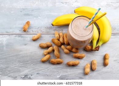 Peanut Butter, Banana, Oat Smoothie On Blue Wooden Background, Selective Focus